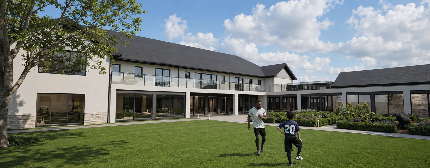 The sheltered courtyard: glazed ground floor, first-floor terrace and the retained steading range